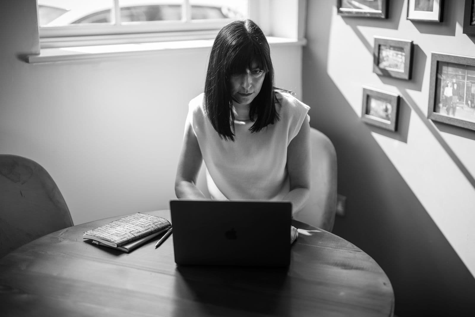 Black and white: Katie Clarke at a laptop by a window