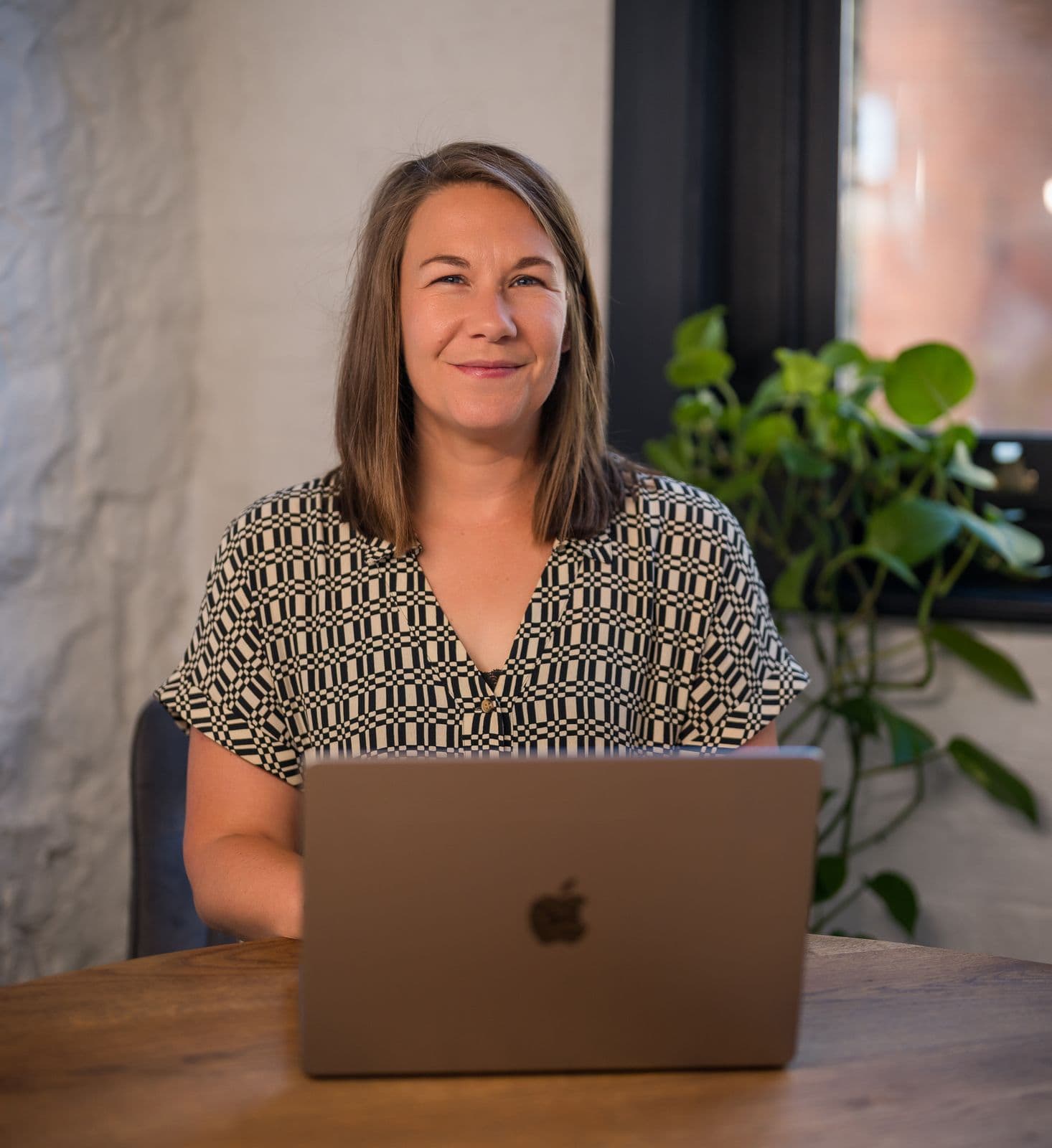 Leanne Terry at a laptop, smiling at the camera