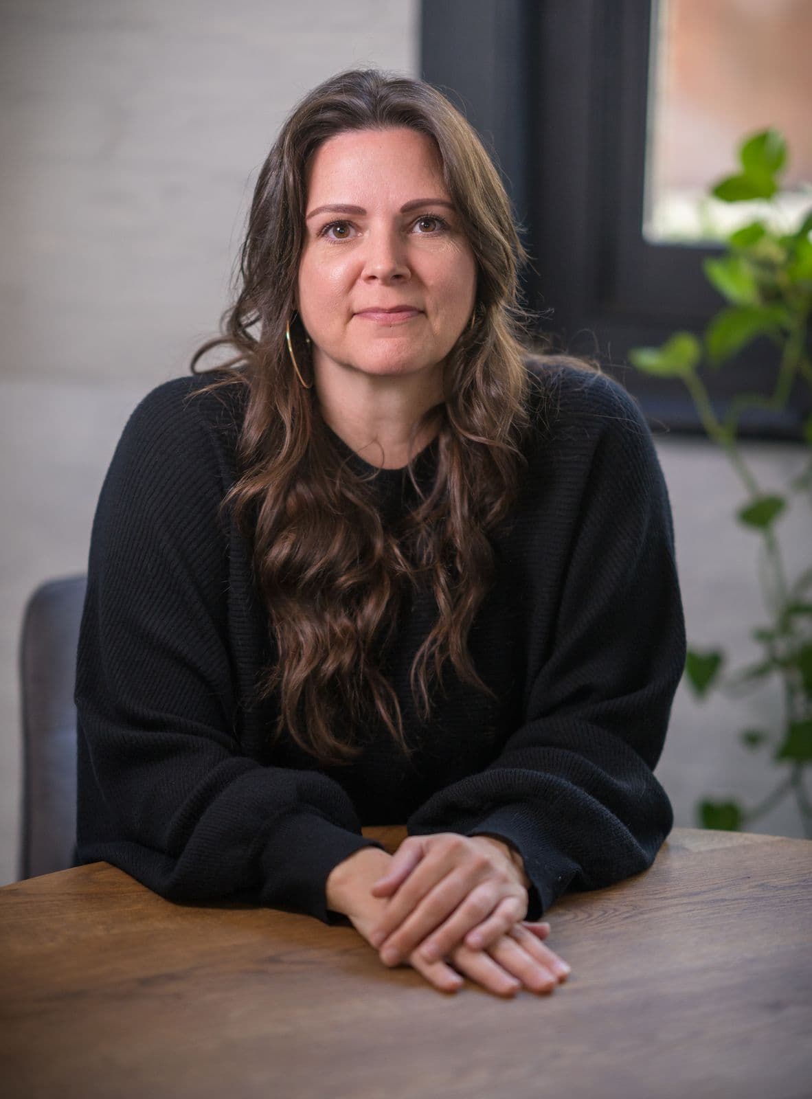A woman with long dark hair, photographed on the Clic HQ filming day, September 2024