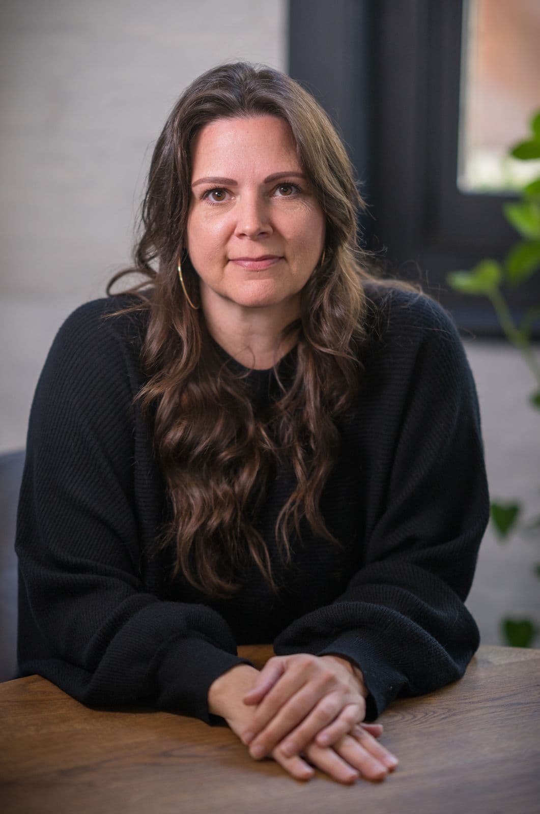 A woman with long dark hair, photographed on the Clic HQ filming day, September 2024