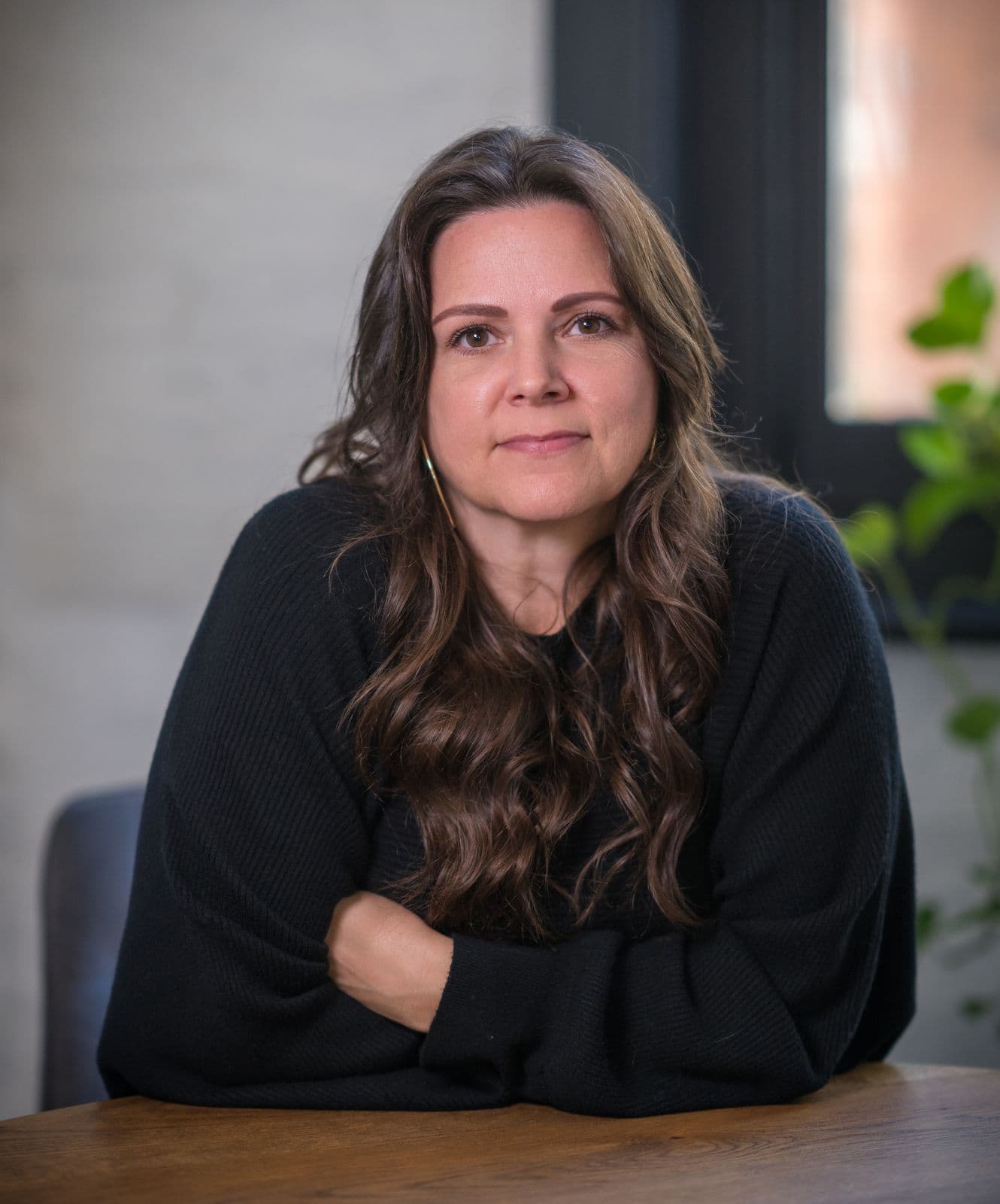A woman with long dark hair, photographed on the Clic HQ filming day, September 2024