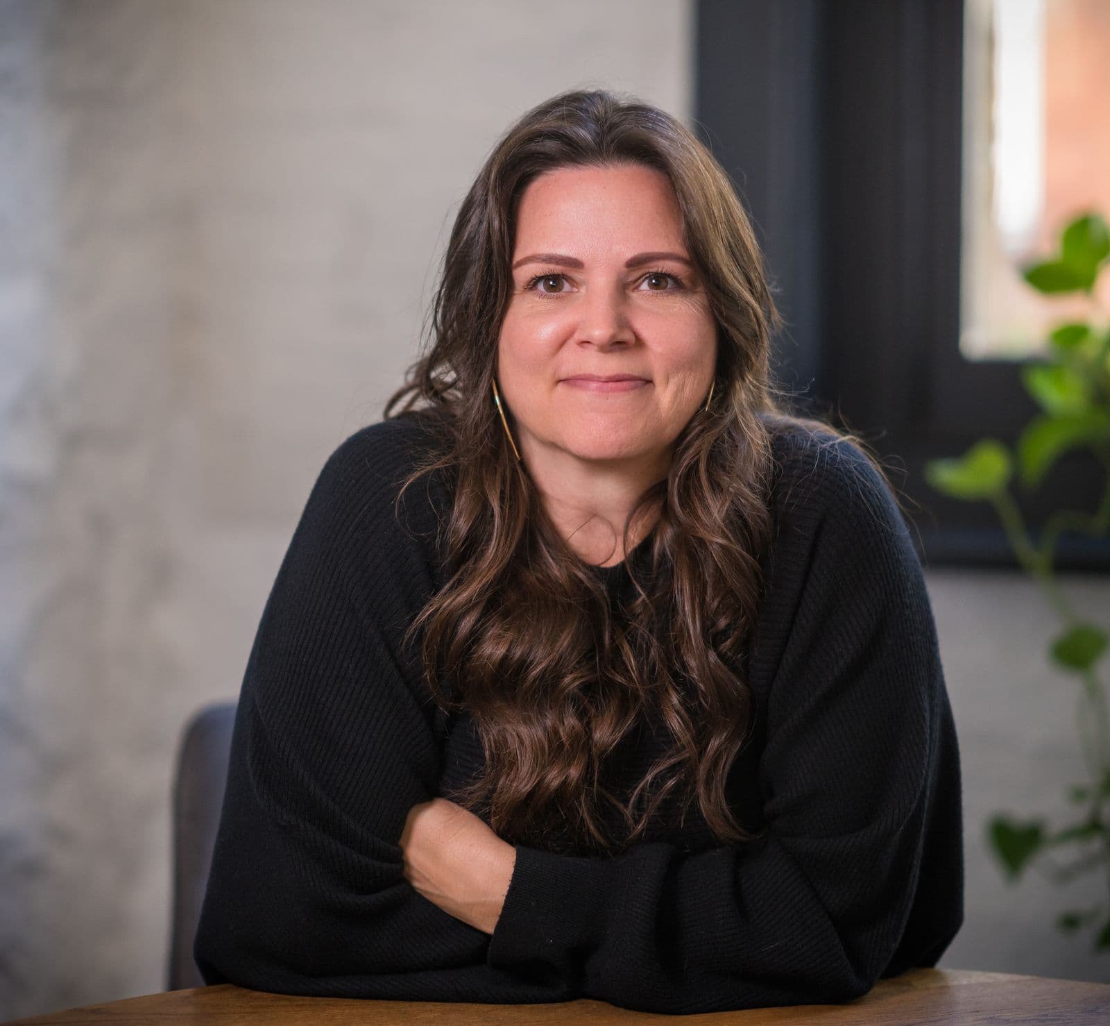 A woman with long dark hair, photographed on the Clic HQ filming day, September 2024