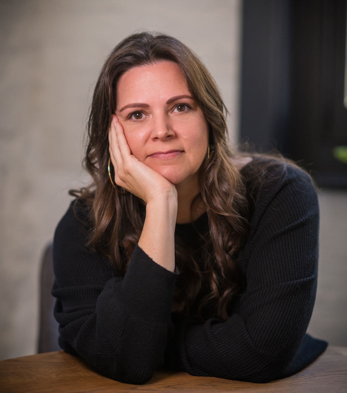 A woman with long dark hair, photographed on the Clic HQ filming day, September 2024