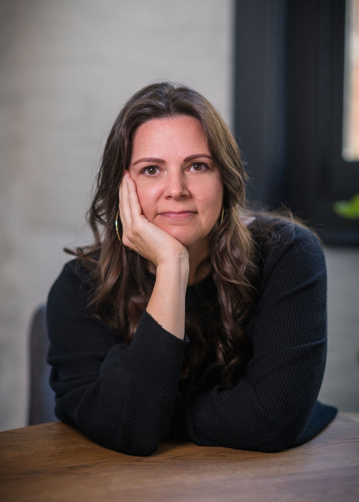 A woman with long dark hair, photographed on the Clic HQ filming day, September 2024