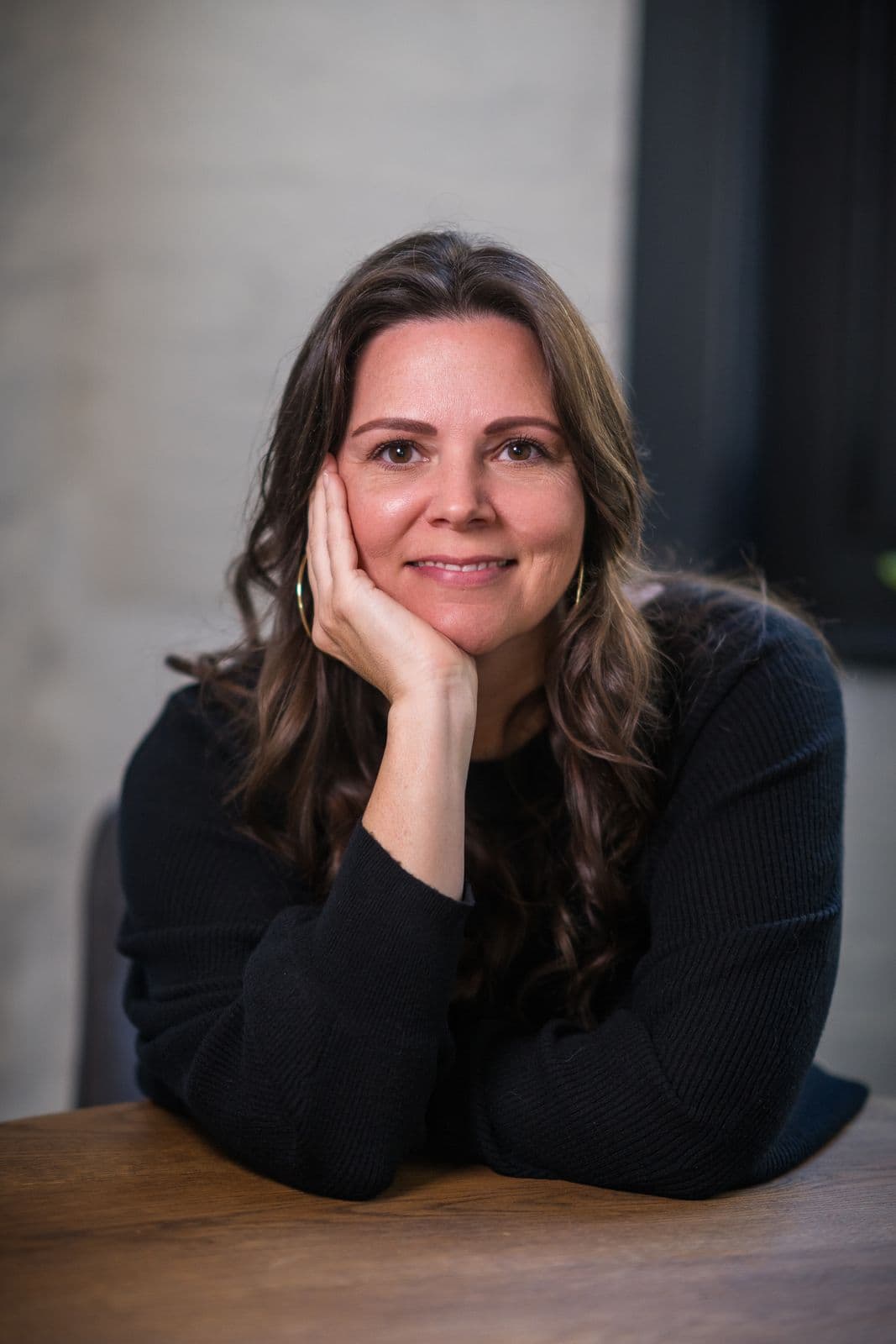 A woman with long dark hair, photographed on the Clic HQ filming day, September 2024