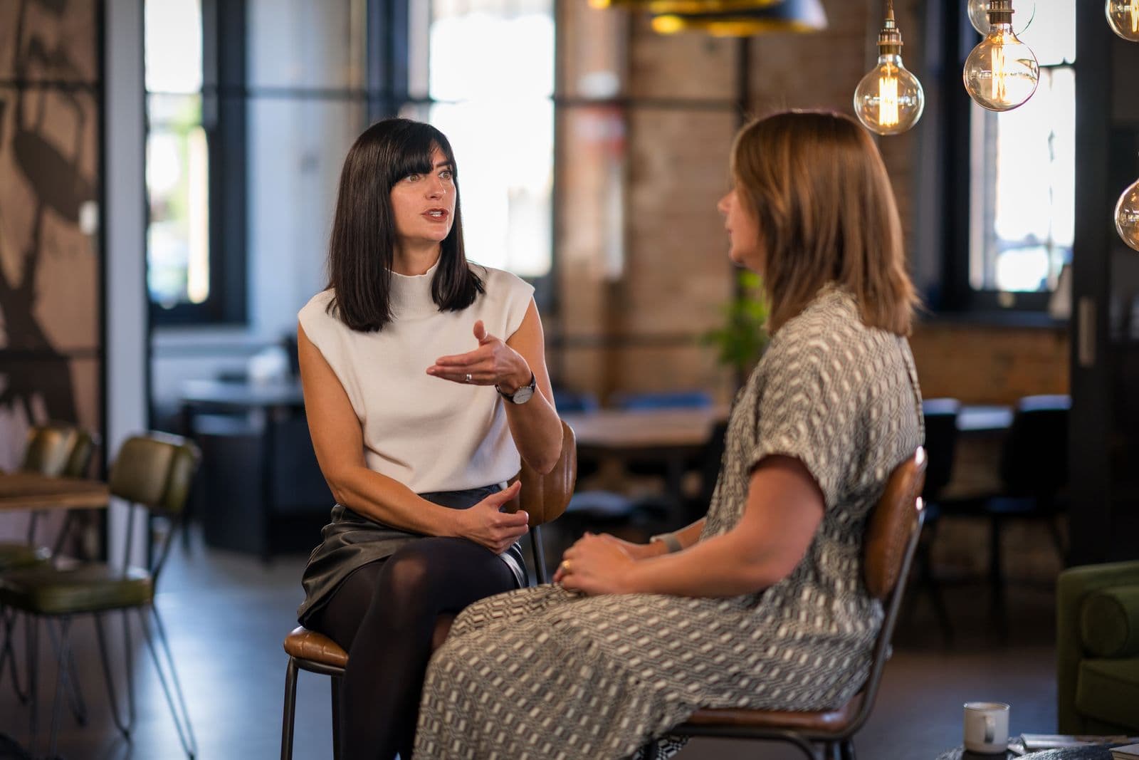 Katie Clarke and Leanne Terry talking in chairs in the venue