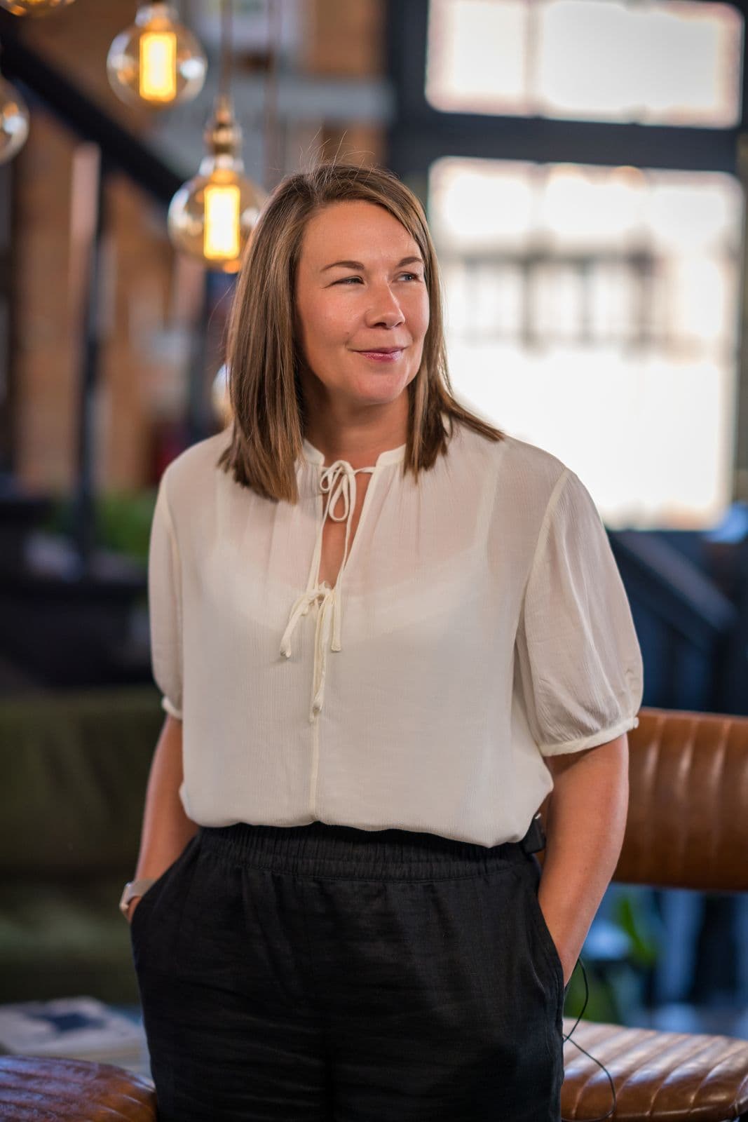 Leanne Terry in a cream blouse, standing in the venue