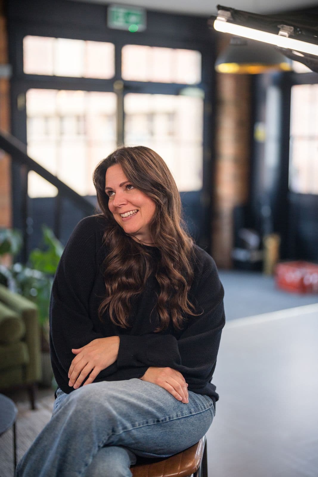 A woman with long dark hair, photographed on the Clic HQ filming day, September 2024