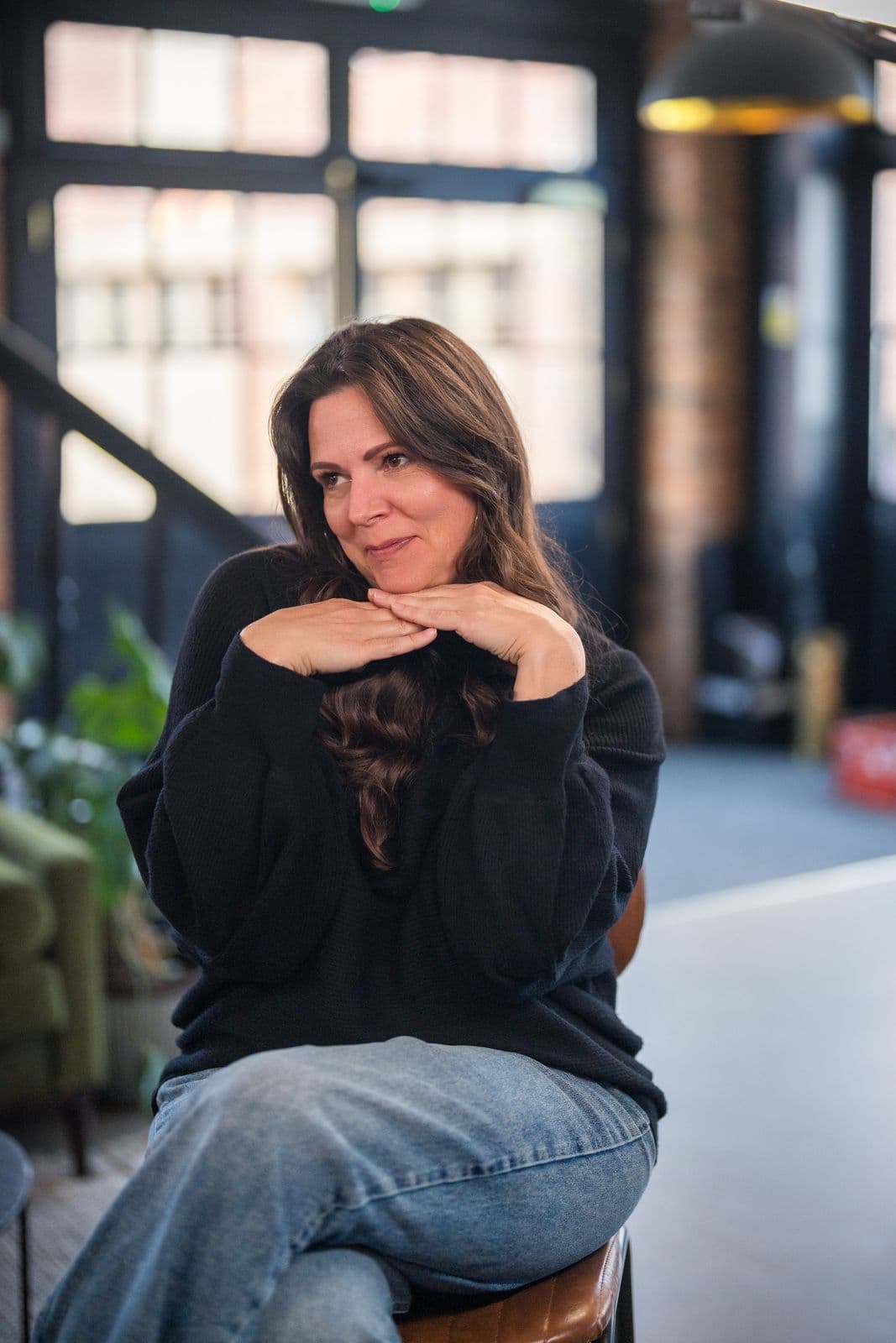A woman with long dark hair, photographed on the Clic HQ filming day, September 2024