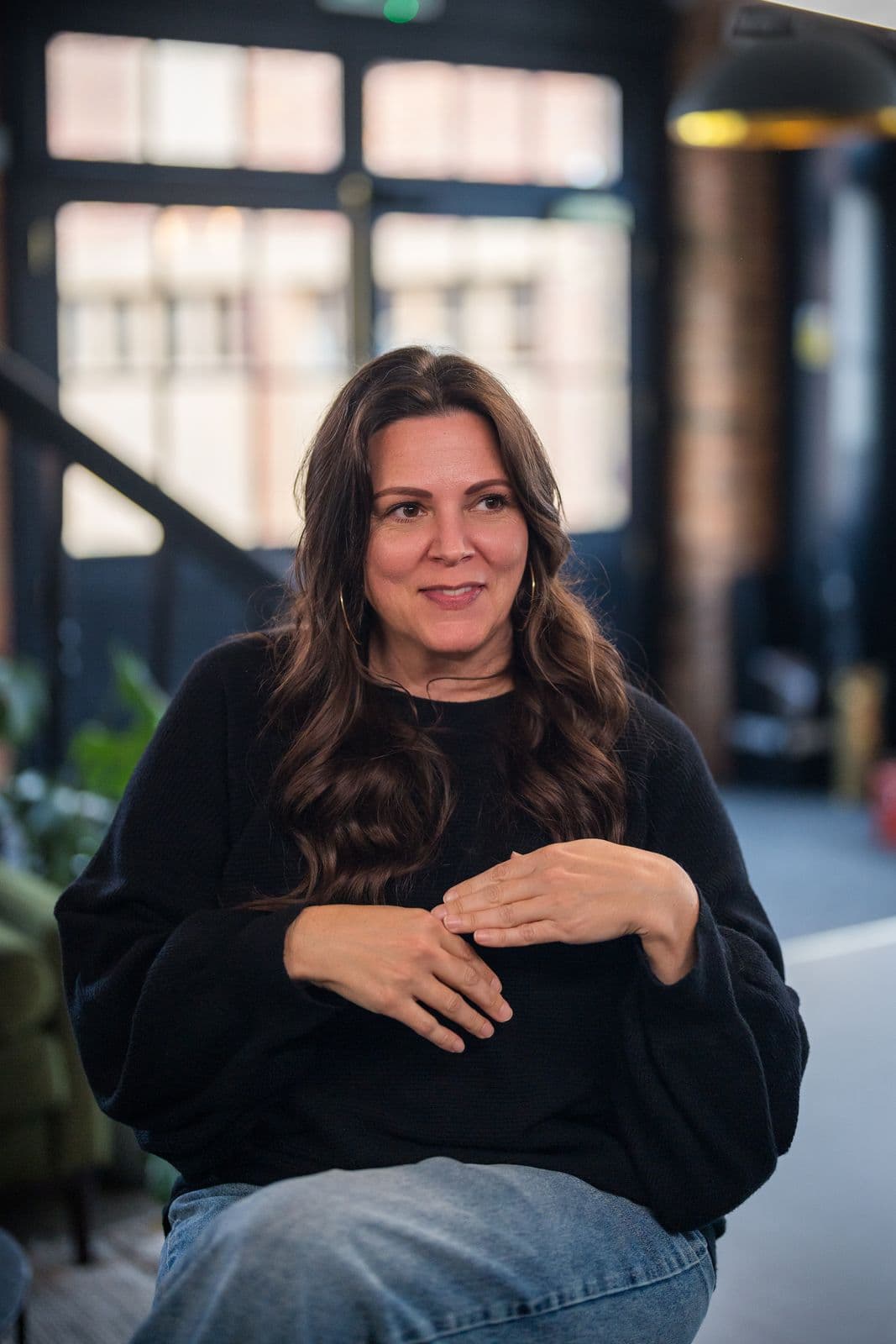 A woman with long dark hair, photographed on the Clic HQ filming day, September 2024
