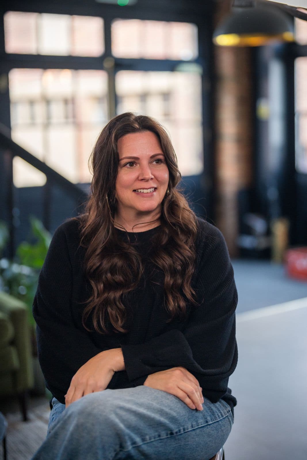 A woman with long dark hair, photographed on the Clic HQ filming day, September 2024