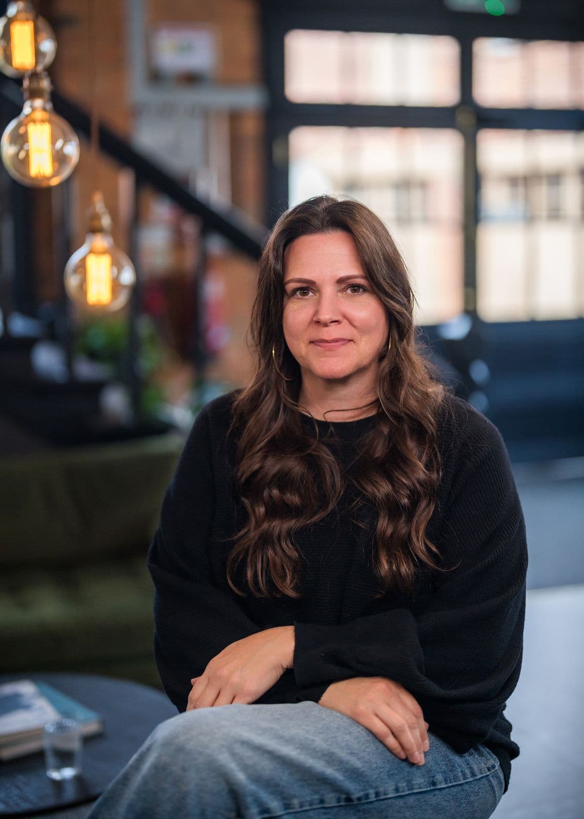 A woman with long dark hair, photographed on the Clic HQ filming day, September 2024