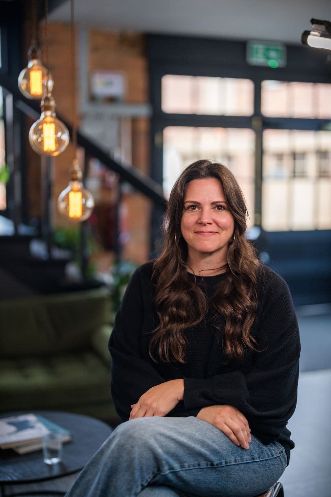 A woman with long dark hair, photographed on the Clic HQ filming day, September 2024