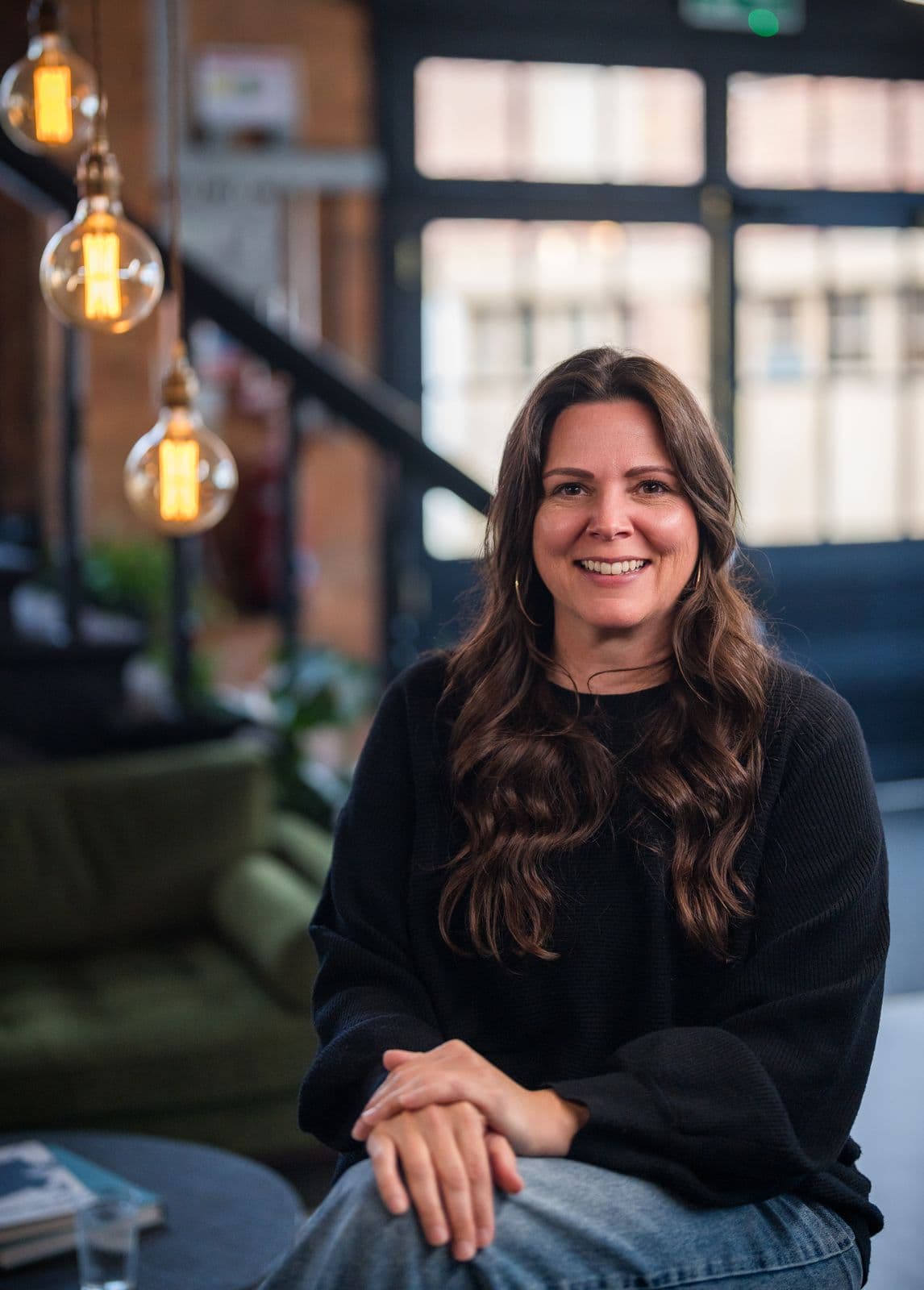 A woman with long dark hair, photographed on the Clic HQ filming day, September 2024