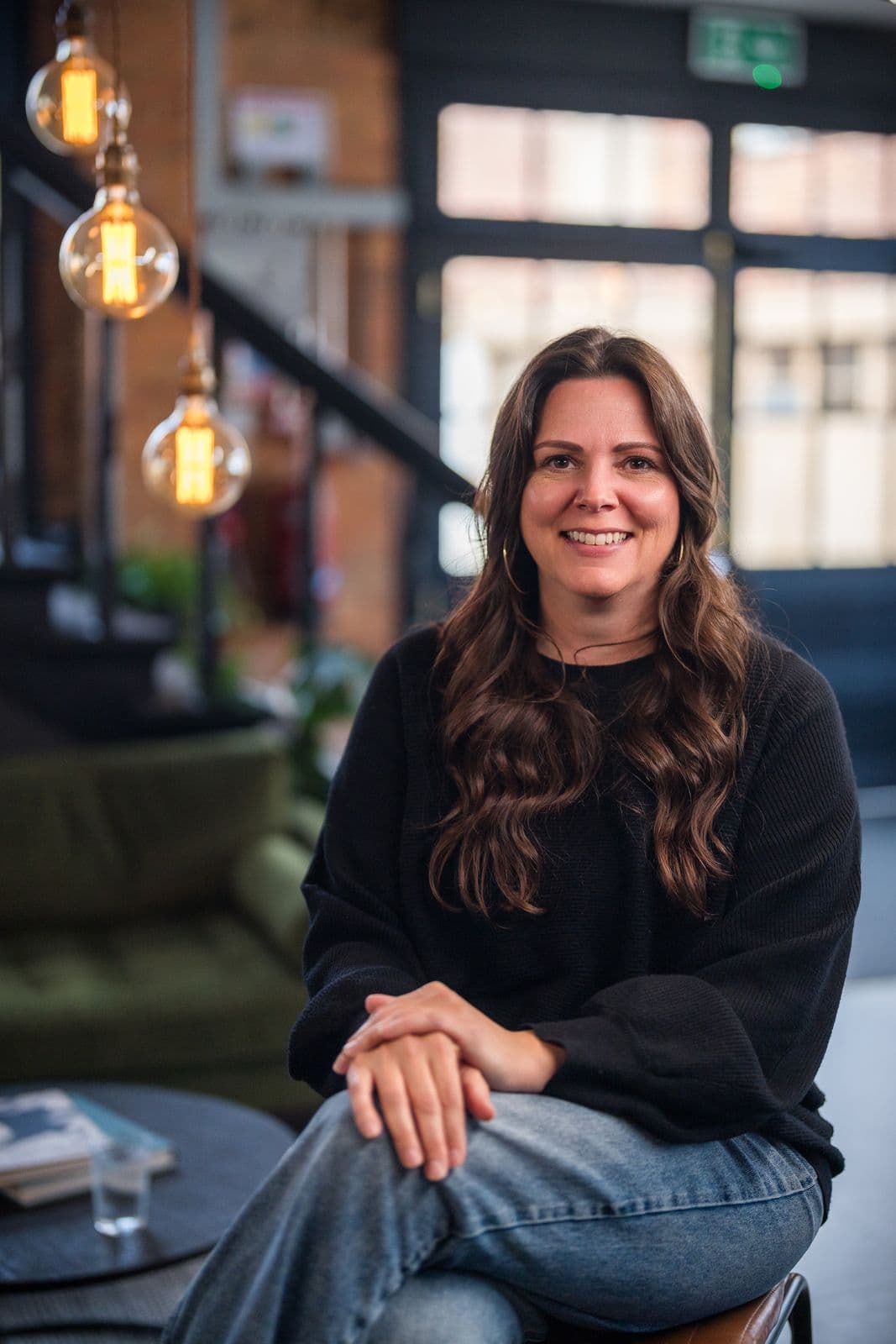 A woman with long dark hair, photographed on the Clic HQ filming day, September 2024