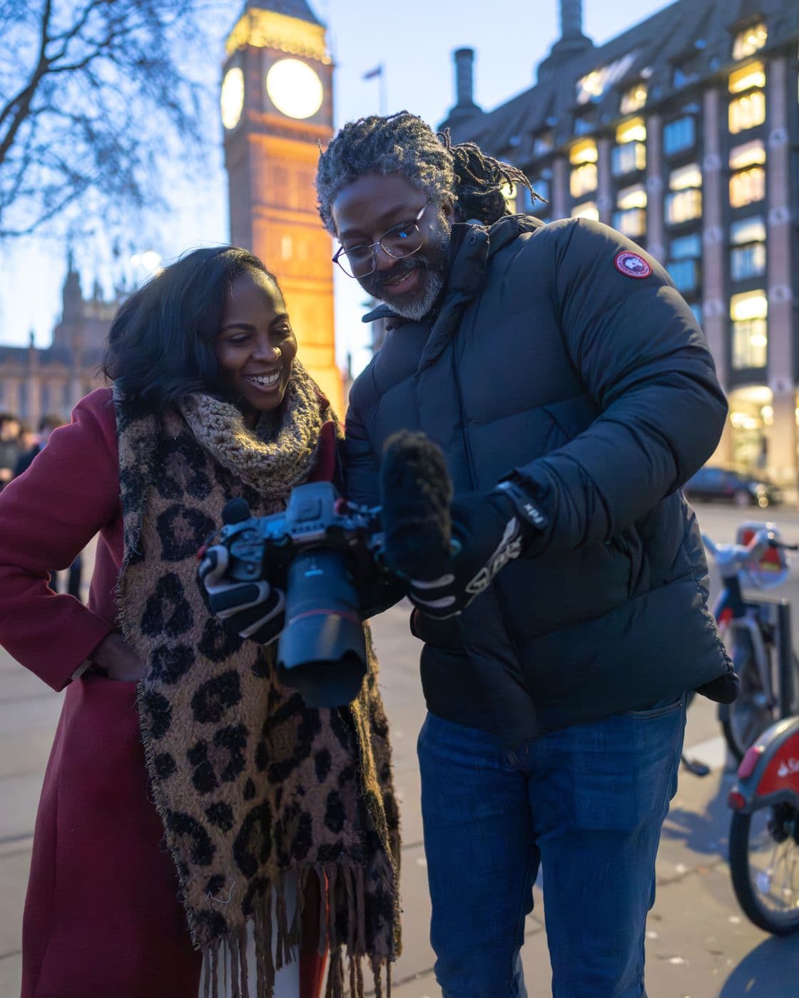 Kevan showing Mecca a take on the camera screen at Westminster, Big Ben behind them, January 2025