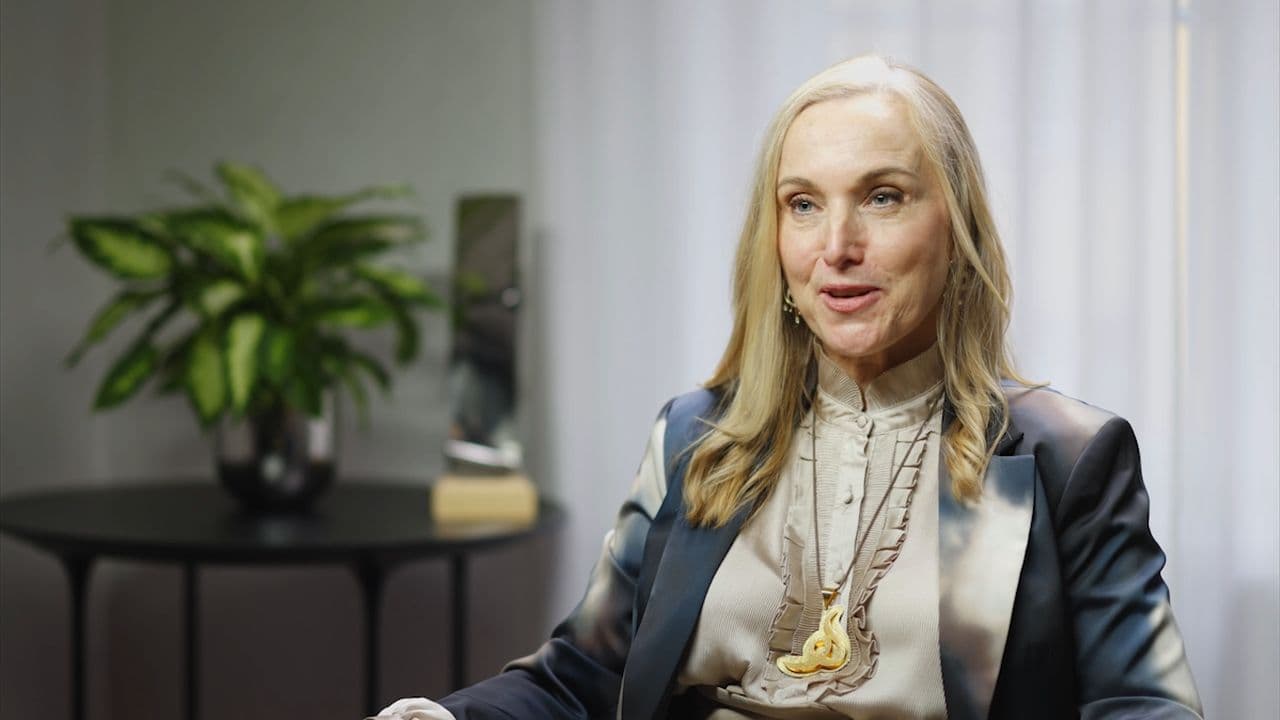 Helene in her interview for the film, a plant and a white curtain behind her